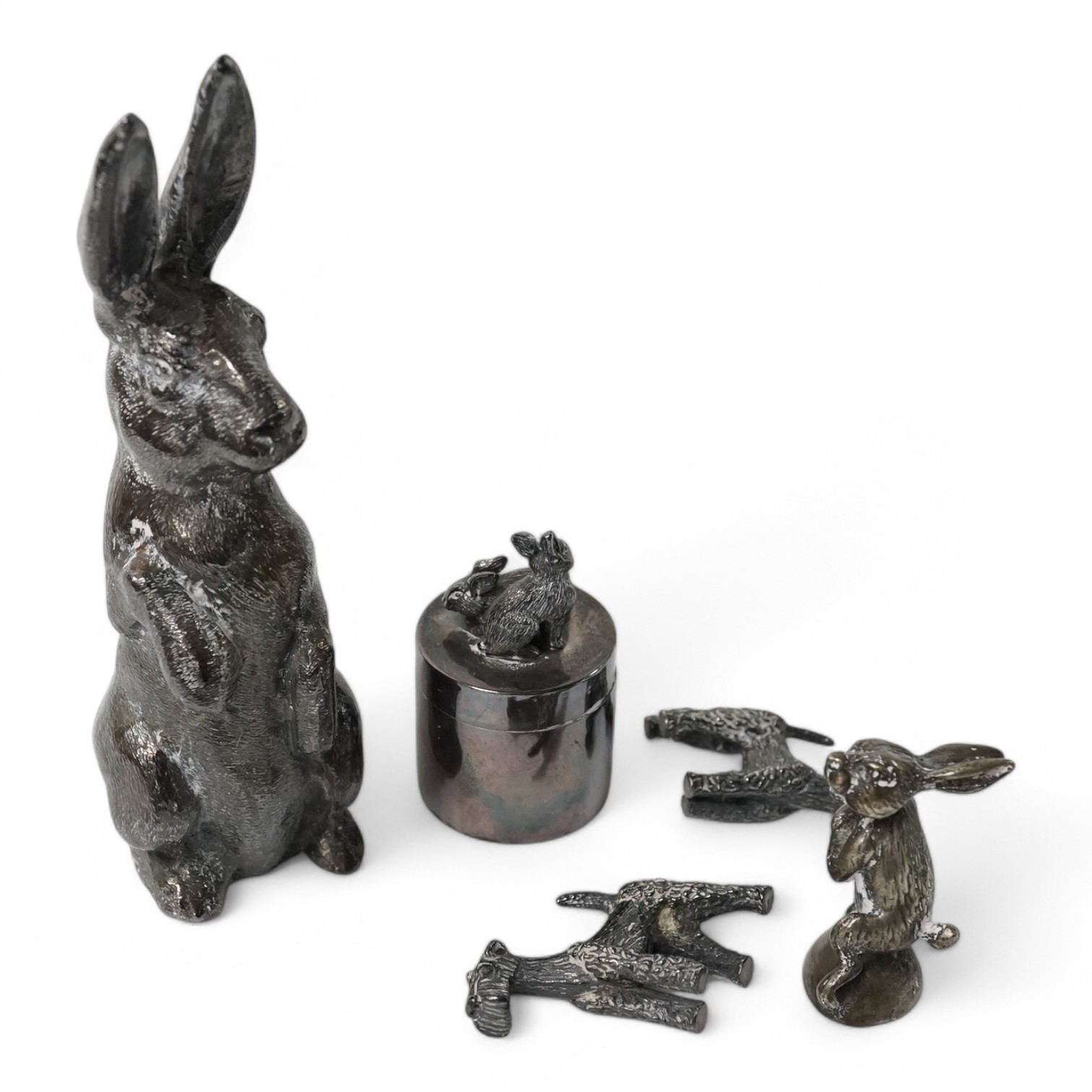 An Elizabeth II silver model of a hare on its haunches, Edward Barnard & Sons, Ltd, London, 1973, 11.8cm, weighted, together with two modern miniature model schnauzers, a modern silver pill box and cover with rabbit surm